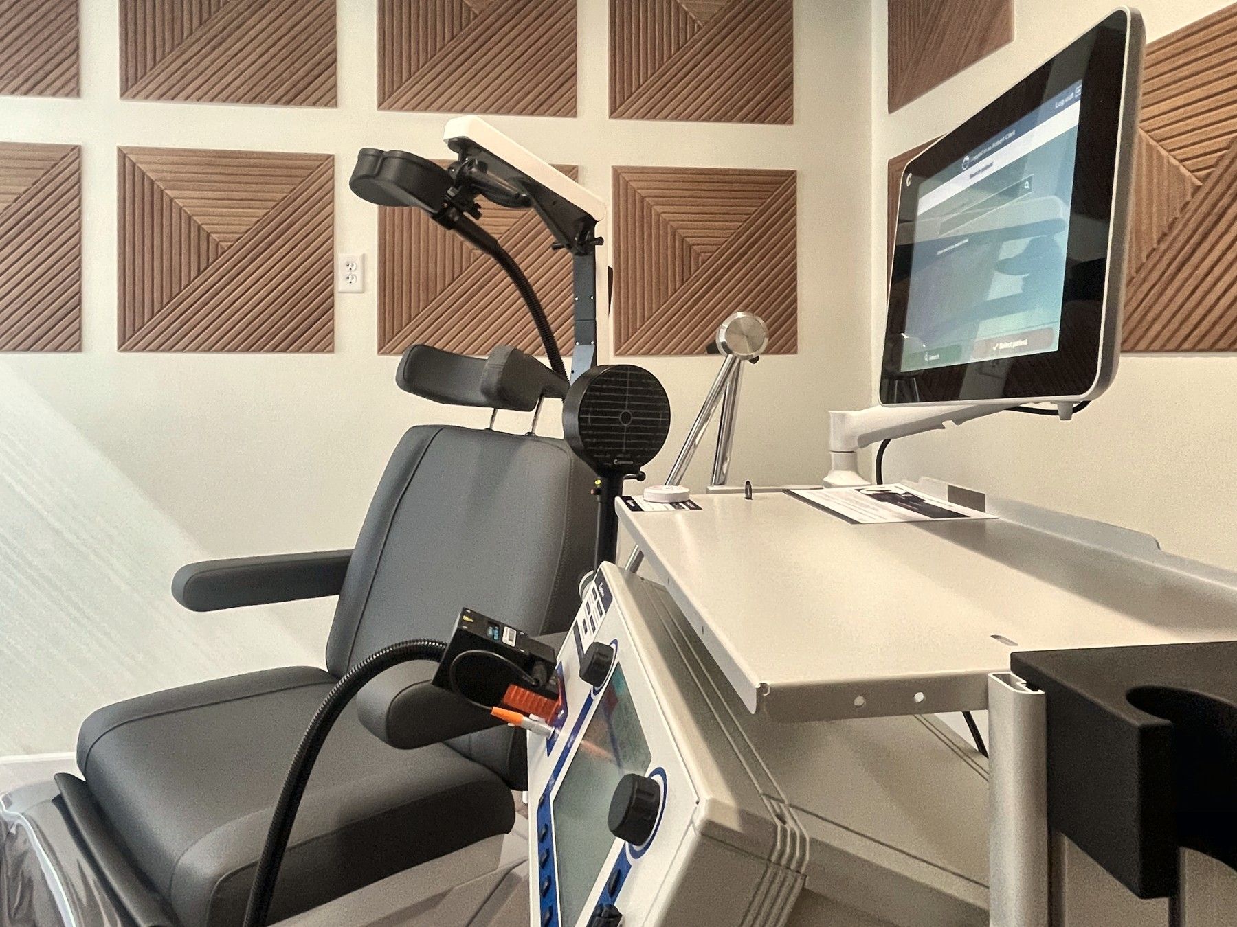 The TMS treatment room at Resilience Neuro Health in Dallas — treatment chair, coil, and console.