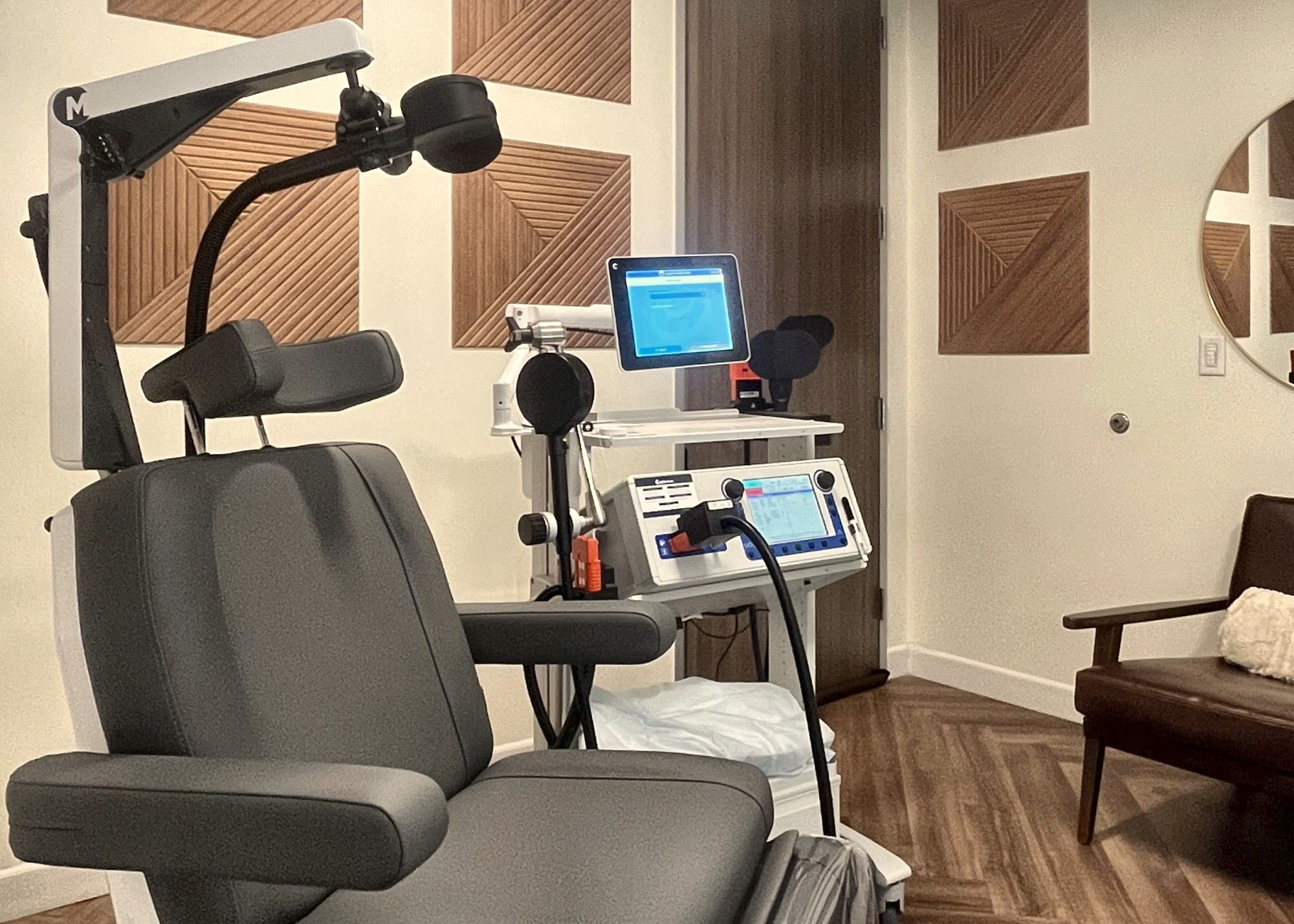 The TMS treatment room at Resilience Neuro Health in Dallas — treatment chair, coil, and monitoring station.