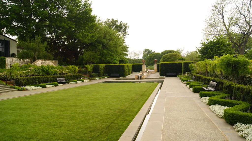 Green lawns, flower beds, and a reflecting pool at the Dallas Arboretum and Botanical Garden.