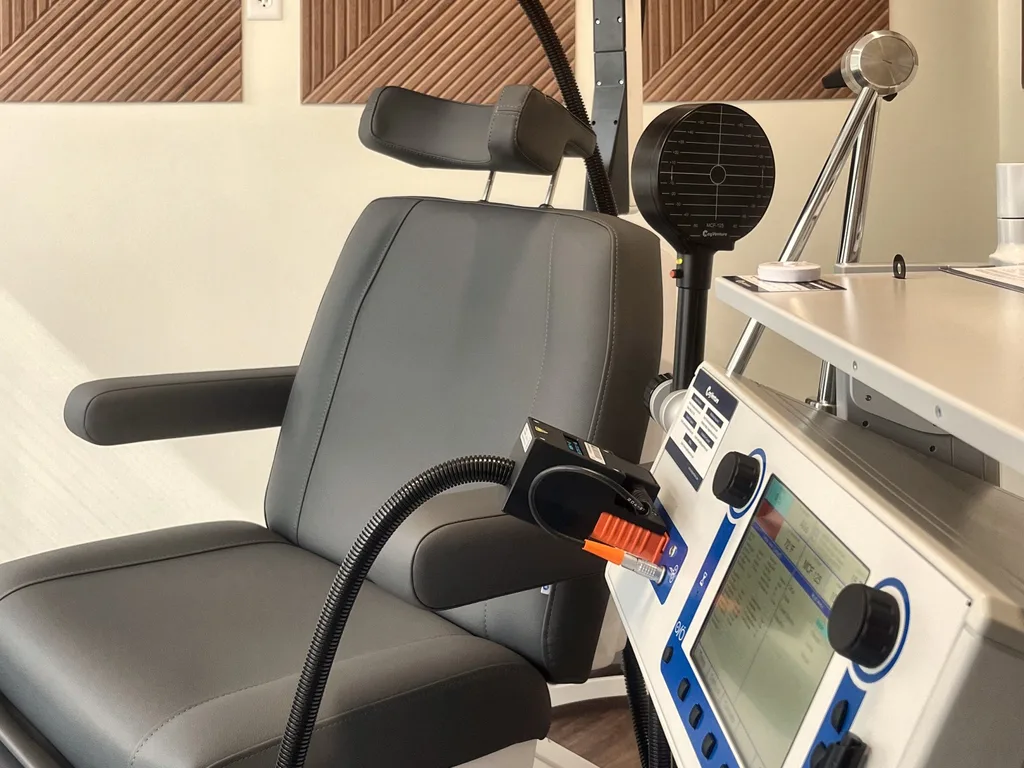 The TMS chair and stimulator up close — treatment is delivered by a device, with no drugs or sedation.